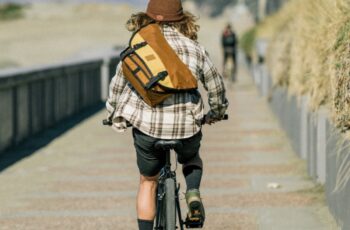 Man on bicycle with Chrome cycling clothing brand sling bag